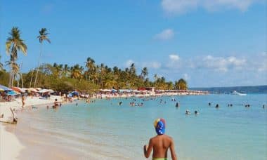 woman in blue bikini walking on beach during daytime