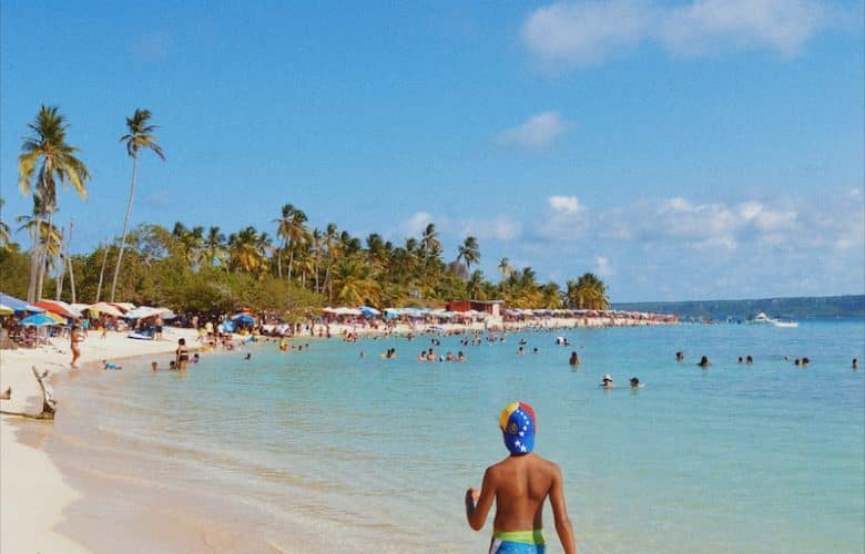 woman in blue bikini walking on beach during daytime