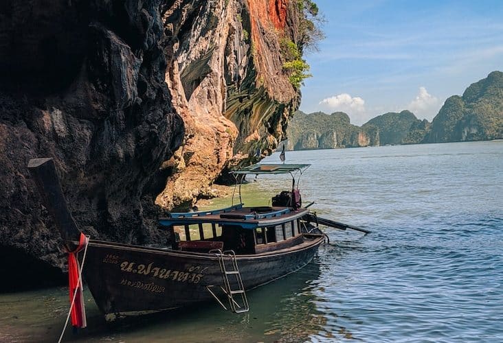 brown boat on sea shore during daytime