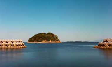 brown rock formation on body of water during daytime